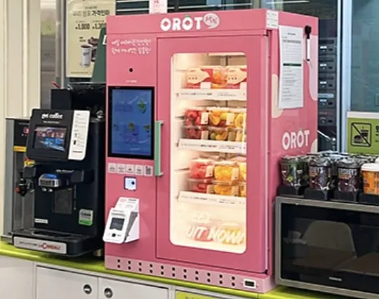 OROT mini on a convenience store counter next to a coffee machine